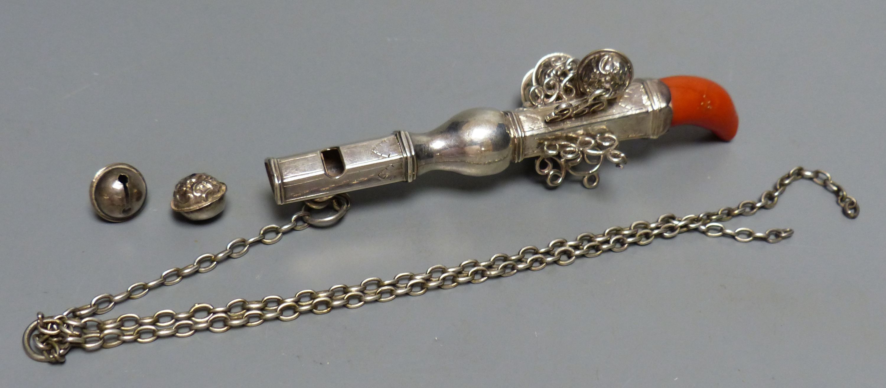 A 19th century? white metal child's rattle with coral teether and seven bells (2 detached) unmarked, 13cm,